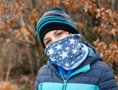 A woman wearing a blue star winter custom fleece neck warmer